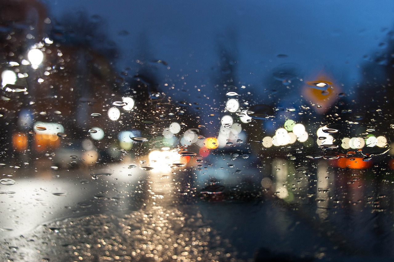 a blurry picture of a city street at night, a picture, shutterstock, realism, day after raining, landscape from a car window, drops of water, bokeh photo