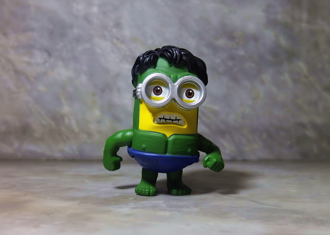 a close up of a toy on a table, a picture, by Hiroyuki Tajima, pexels, neo-dada, he looks like a human minion, muscular! green, marvel character, matt groening style