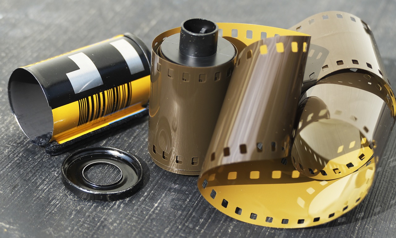 a roll of film sitting on top of a table, a picture, kodachrome camera, animated film, kodak gold film, celluloid