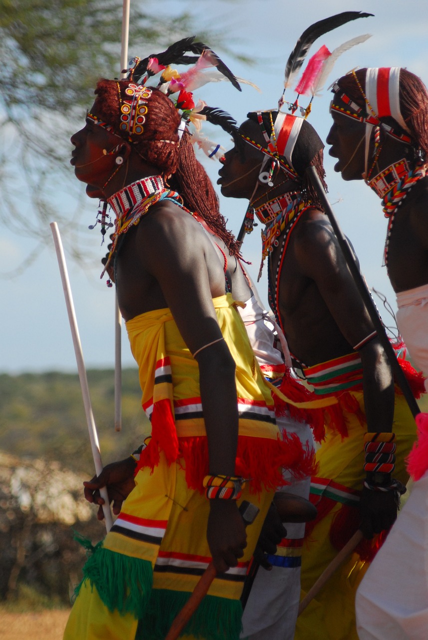 a group of people standing next to each other, by Ingrida Kadaka, flickr, hurufiyya, massai warrior, close up shot from the side, people dancing, on the african plains