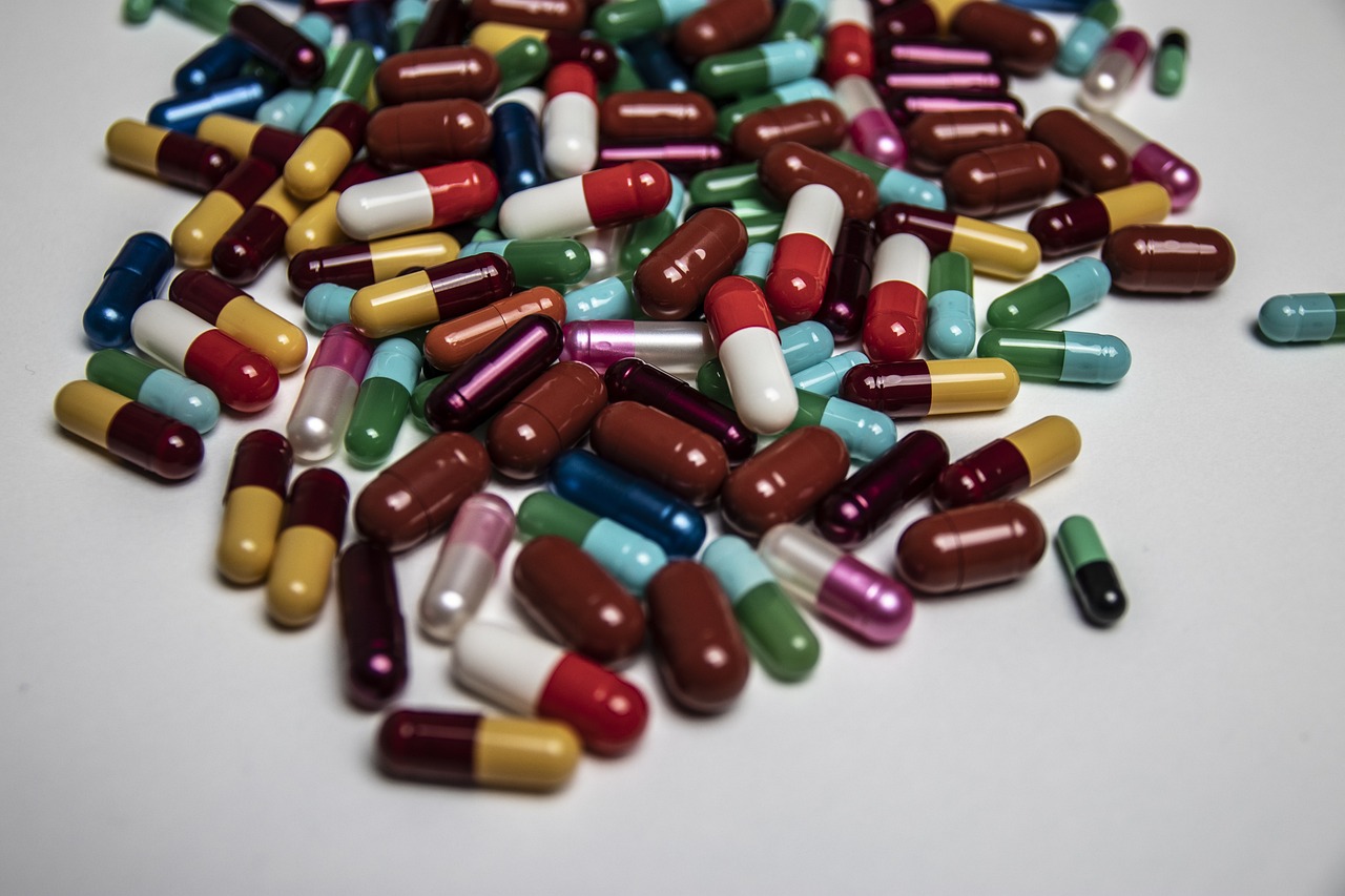 a pile of pills sitting on top of a table, by Eugeniusz Zak, plasticien, multicolor, high quality product image”