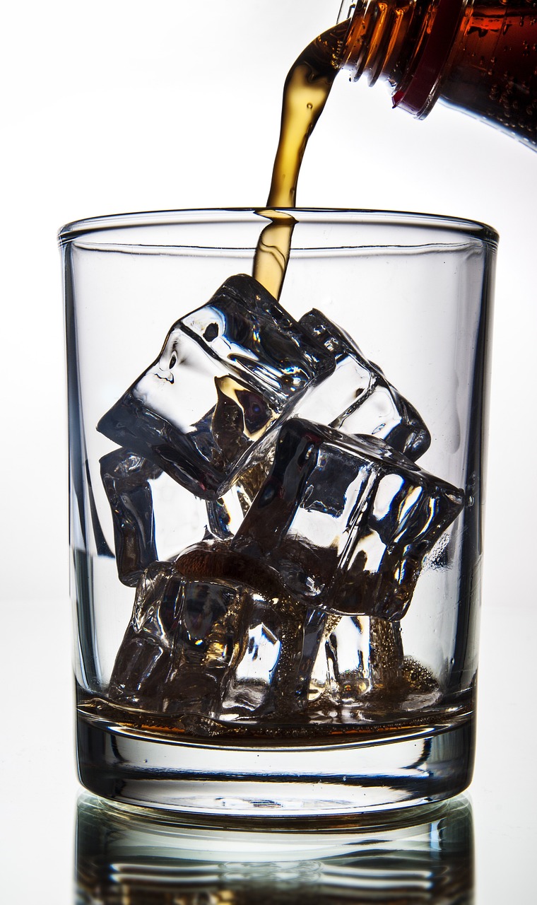 a bottle of beer being poured into a glass filled with ice cubes, a portrait, by Jan Rustem, pexels, photorealism, bismuth cups, istockphoto, drinking a glass of whiskey, platon