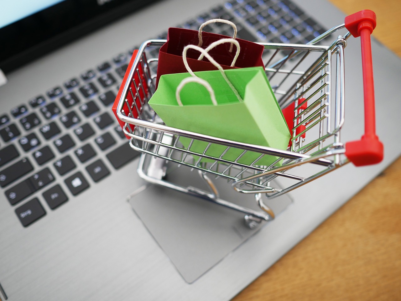 a shopping cart sitting on top of a laptop computer, shutterstock, bags, high angle close up shot, detailed product photo