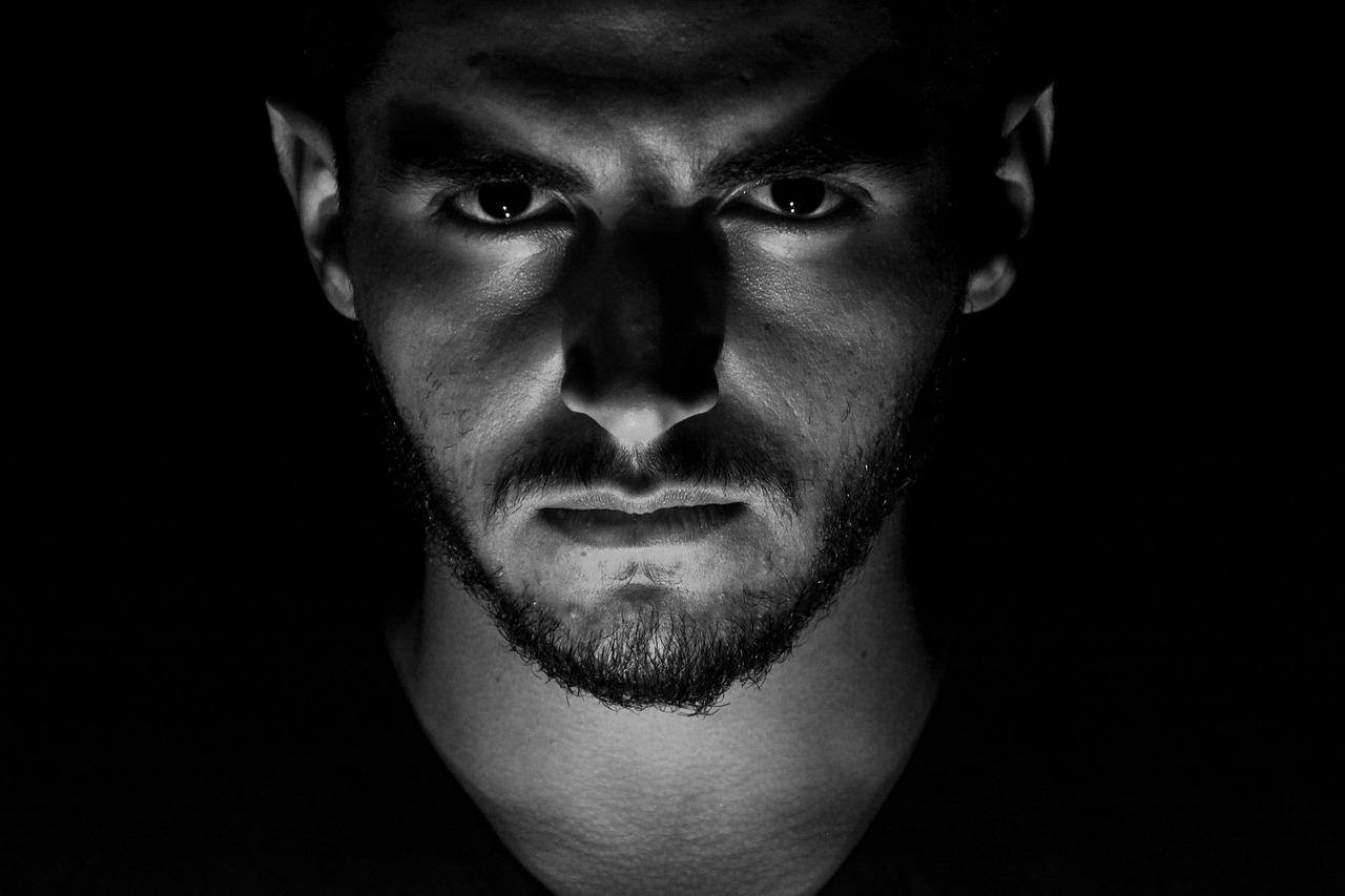 a black and white photo of a man in the dark, a black and white photo, pexels, angry eyes, arab man light beard, portrait of adam jensen, dramatic portraiture of namenlos