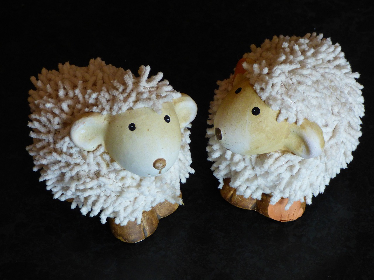 a couple of fake sheep sitting next to each other, by Fiona Stephenson, flickr, mingei, eyes made out of macaroni, hedgehog, bottom - view, esher
