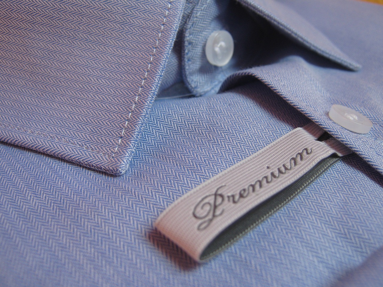 a close up of a label on a shirt, behance, purism, dress shirt and tie, photo realistic”, poseidon, ultrafine detail ”