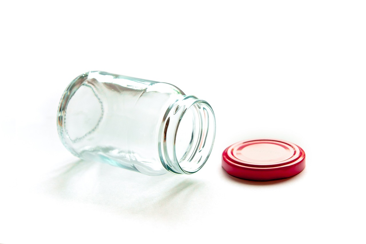 a close up of a glass jar with a red lid, minimalism, 8 0 mm photo, istockphoto, close-up product photo, pathetic