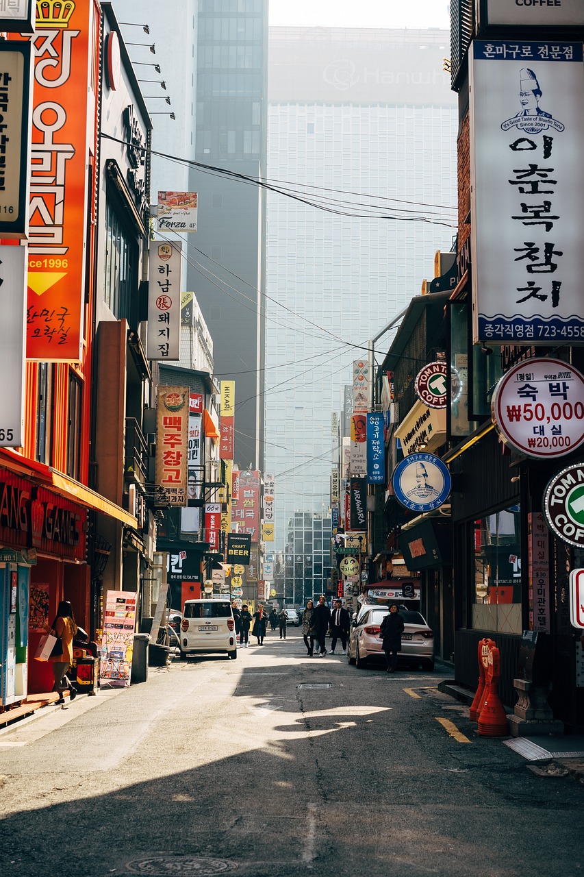 a city street filled with lots of tall buildings, a picture, by Jang Seung-eop, pexels, 🕹️ 😎 🔫 🤖 🚬, signboards, 7 0 - s, traditional korean city