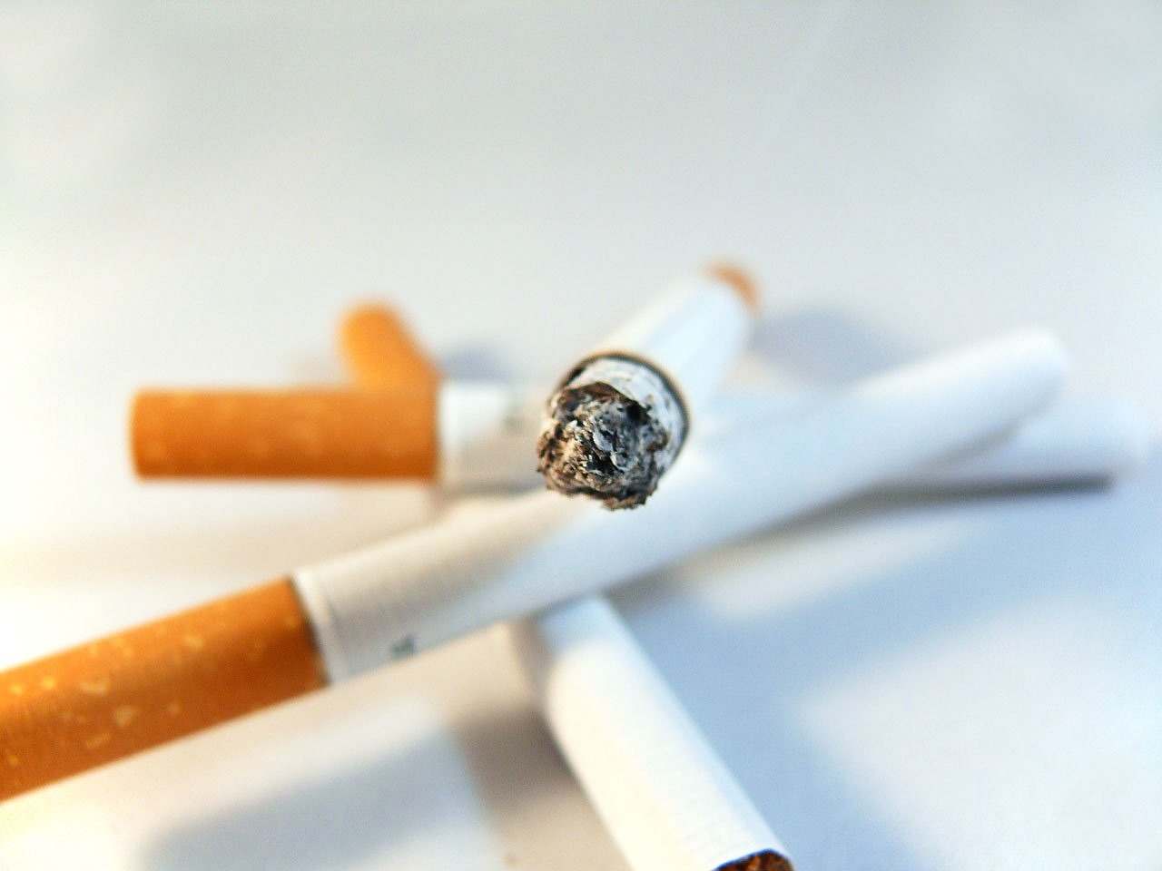 a couple of cigarettes sitting next to each other, a macro photograph, by Maksimilijan Vanka, happening, istockphoto, stubbles, ring of fire, modern high sharpness photo