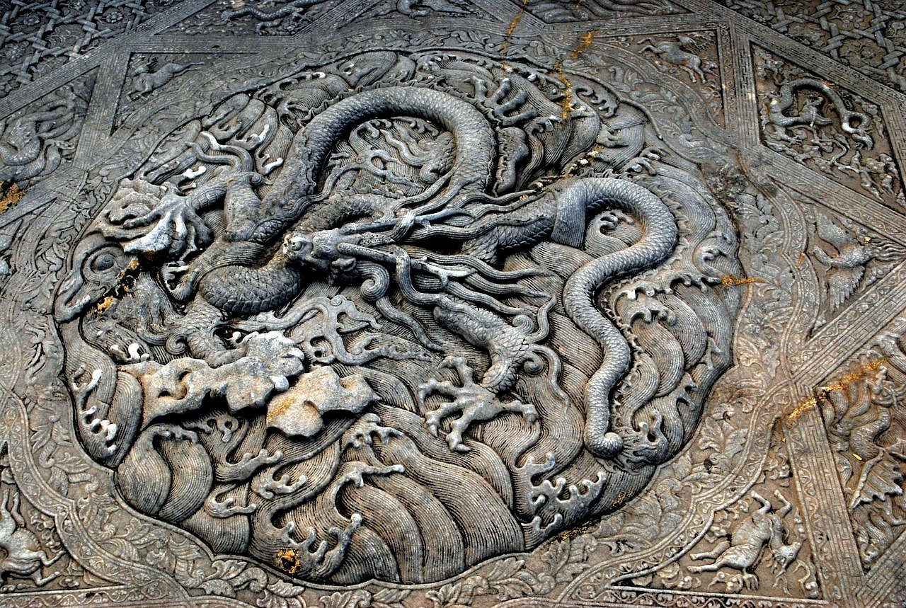 a close up of a stone carving with a dragon on it, inspired by Li Keran, concrete art, ornate tentacles growing around, carved floor, highly detailed digital artwork, viewed from above