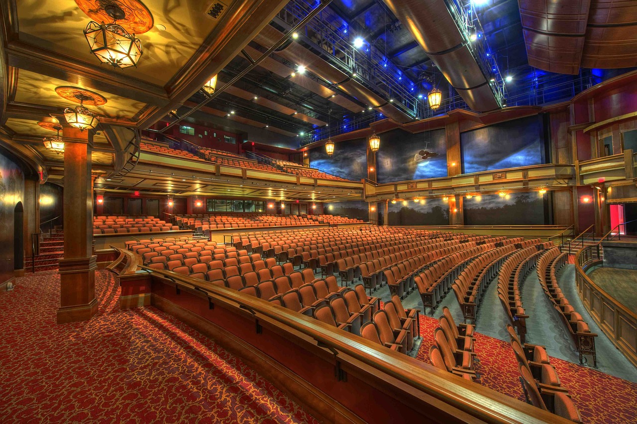 a large auditorium with rows of empty seats, mgm studios, beautiful surroundings, savannah, high res