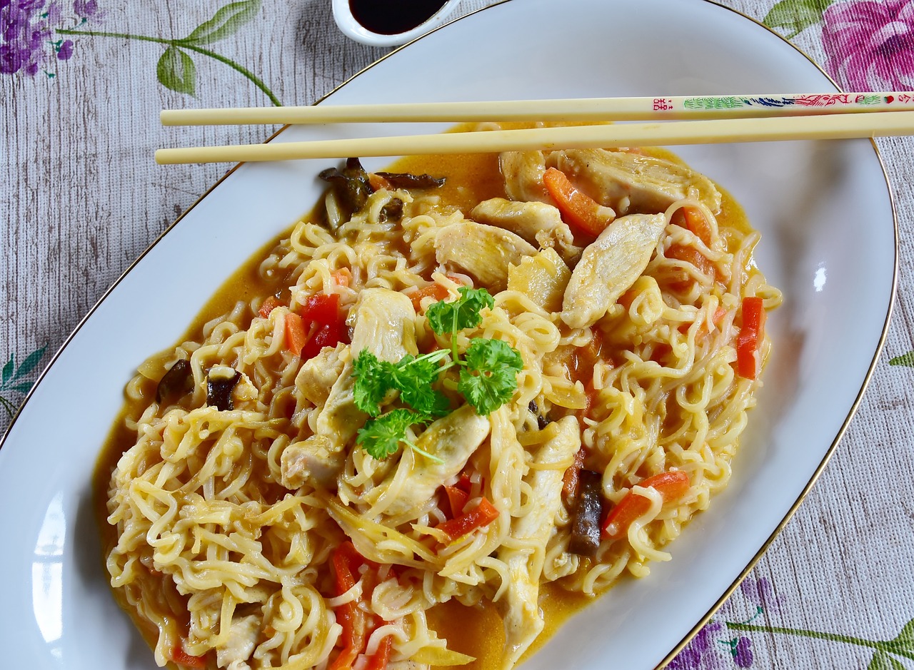 a close up of a plate of food with chopsticks, a picture, pixabay, fantastic realism, noodles, chicken, stock photo, lei min