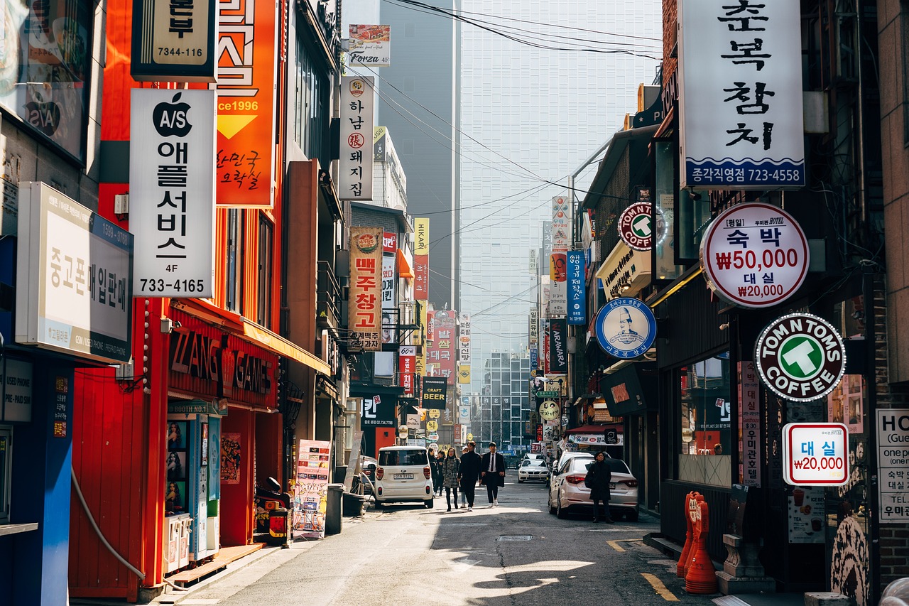 a city street filled with lots of signs, a picture, by Jang Seung-eop, pexels, mingei, 🕹️ 😎 🔫 🤖 🚬, sunny morning, 2070s, city of pristine colors