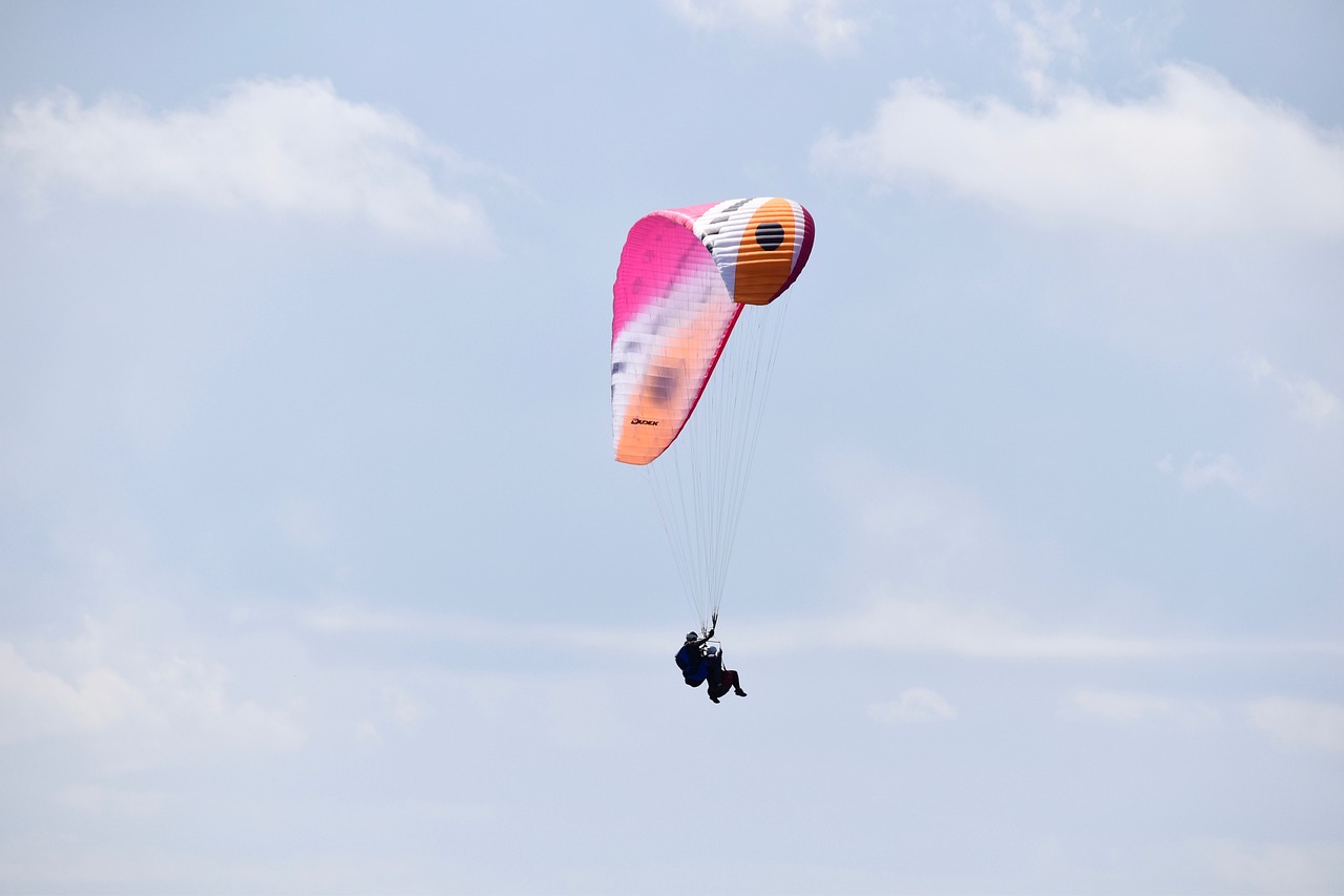 a person parasailing in the sky on a sunny day, a photo, figuration libre, high res photo