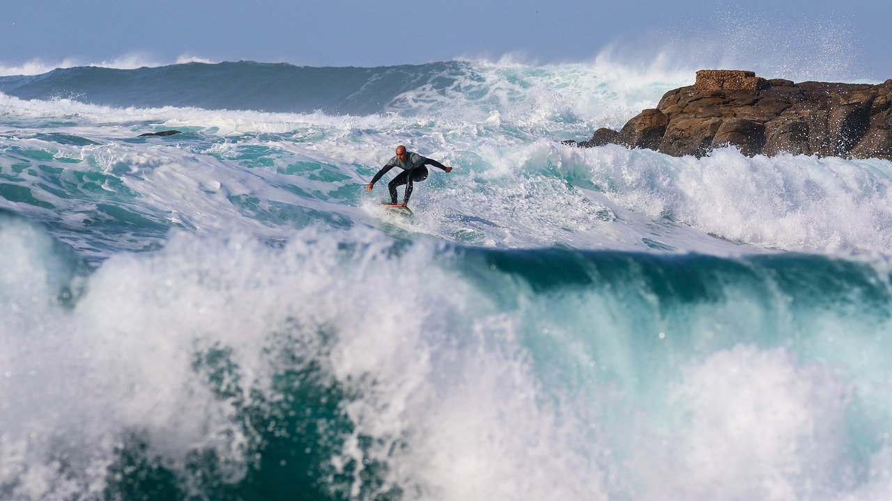 a man riding a wave on top of a surfboard, by Tom Bonson, pexels, south african coast, afp, extreme panoramic, cornwall