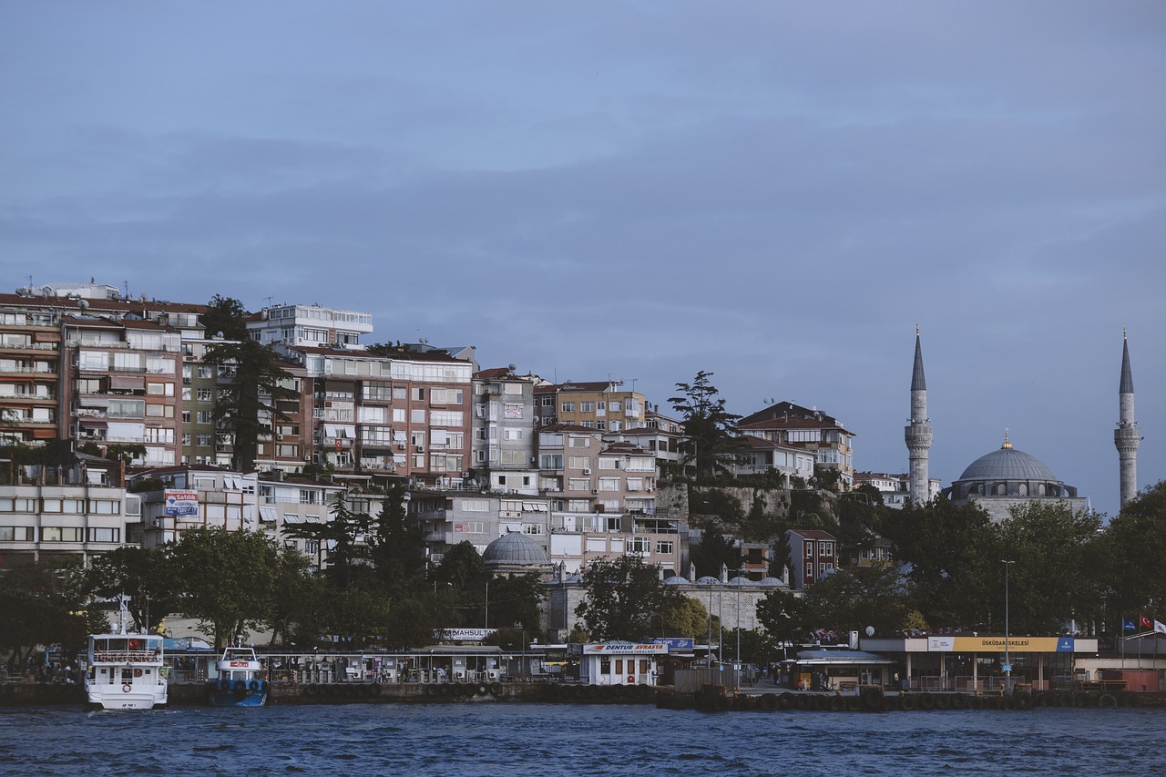 a large body of water with a bunch of buildings in the background, pexels, hurufiyya, turkey, late summer evening, 50mm photo, photo taken from a boat