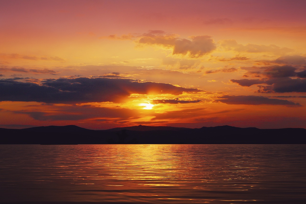 the sun is setting over a body of water, a picture, by Andrei Kolkoutine, shutterstock, romanticism, rich picturesque colors, bright vivid colors, summer night, dramatic cloudy setting sun