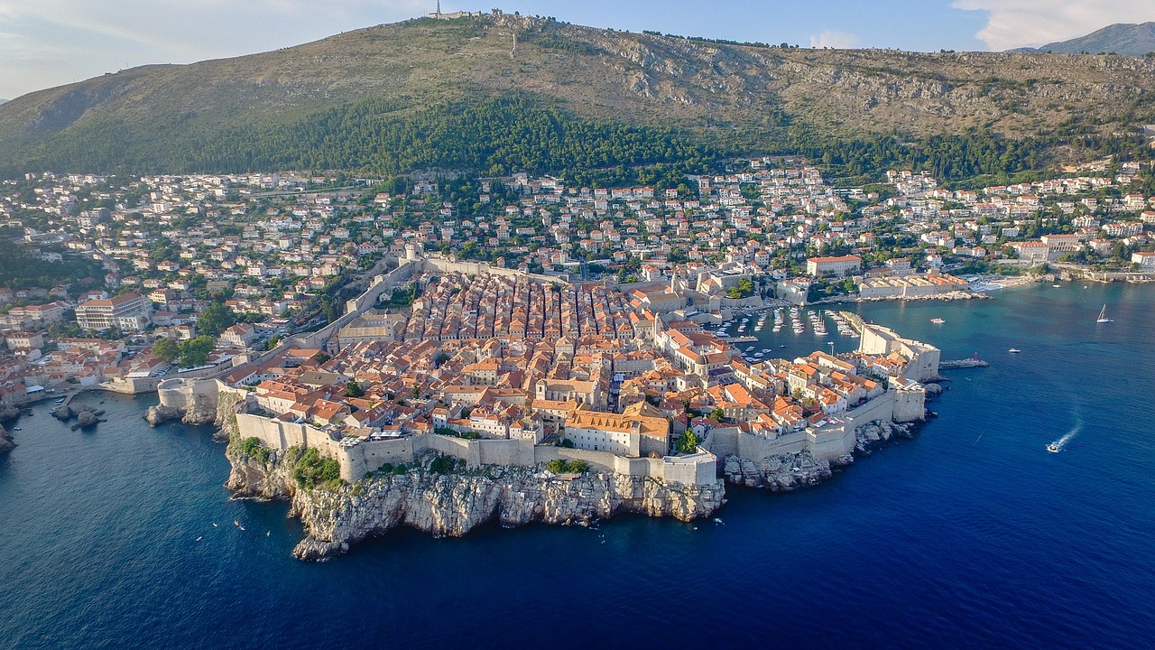 a small island in the middle of a body of water, a picture, renaissance, dubrovnik, aerial view of a city, city walls, sprawling