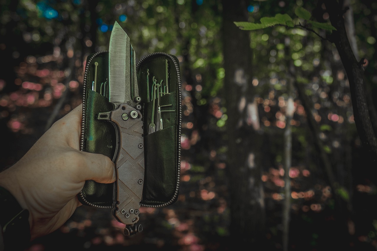 a person holding a knife in a case in the woods, by Adam Marczyński, highly detailed product photo, highly detailed. post processing, high quality product image”, highly mechanical