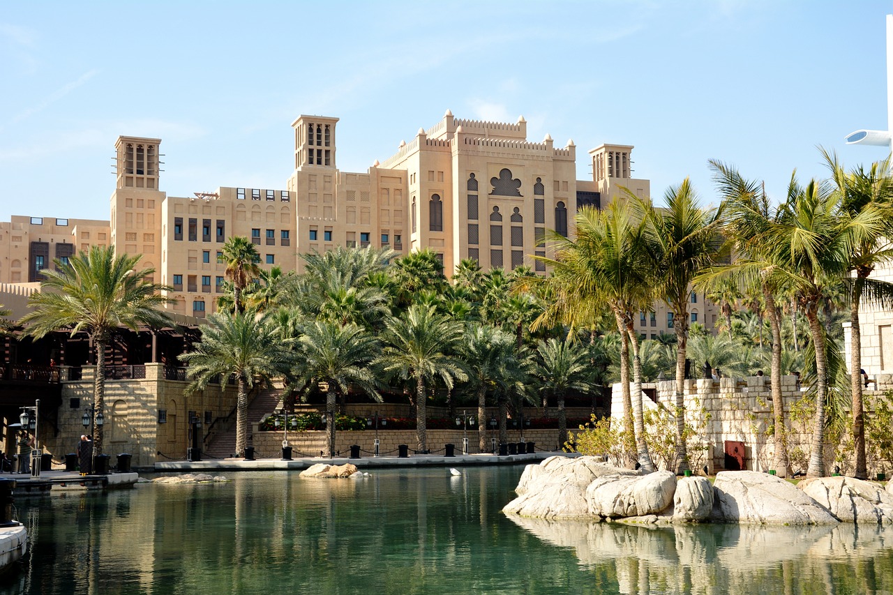 a body of water with palm trees and buildings in the background, a stock photo, by Bernardino Mei, shutterstock, art nouveau, dubai, located in hajibektash complex, july 2 0 1 1, mgm studios