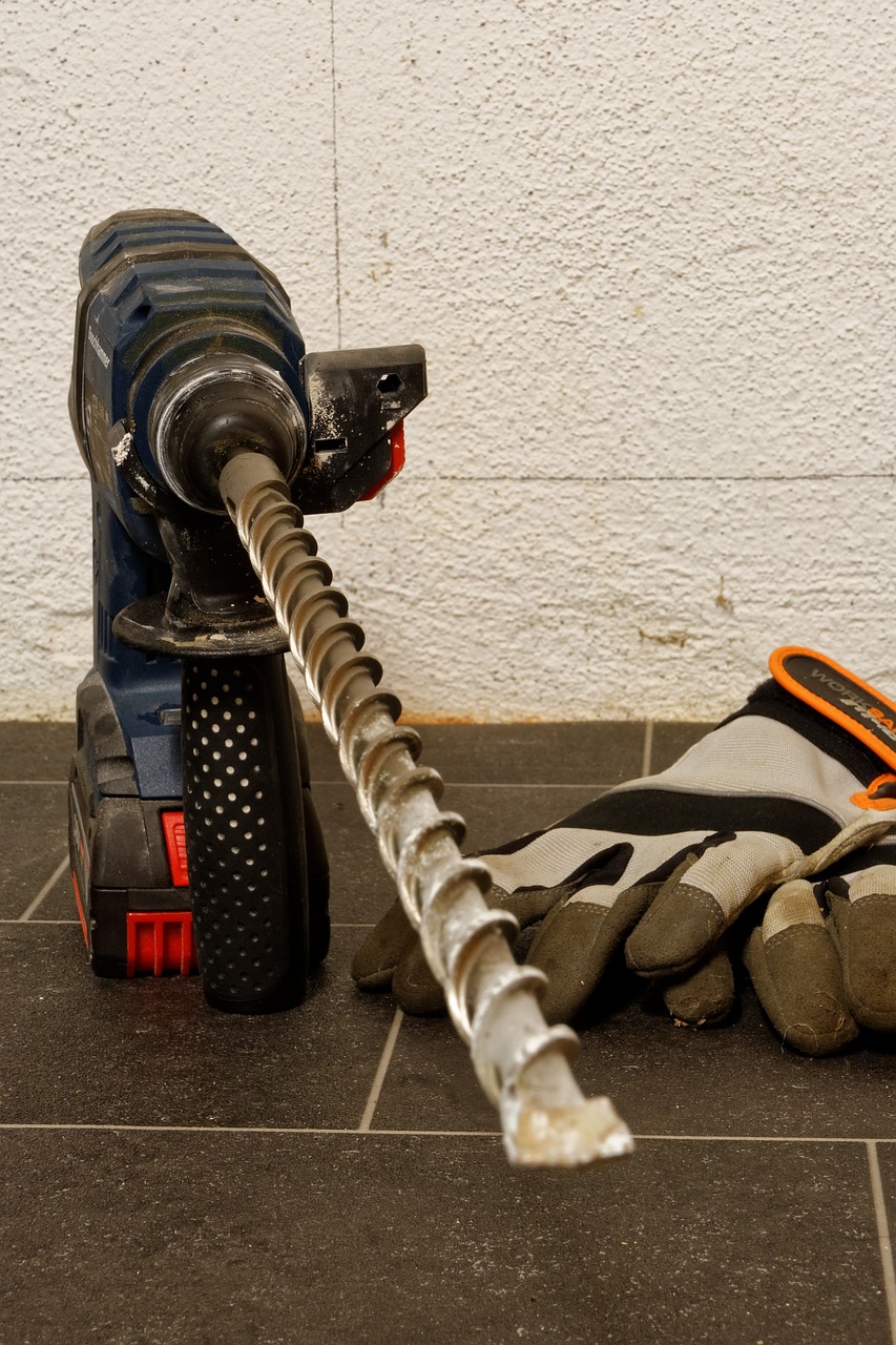 a close up of a drill and gloves on a tiled floor, bauhaus, ropes, maintenance photo, giant hammer, full height