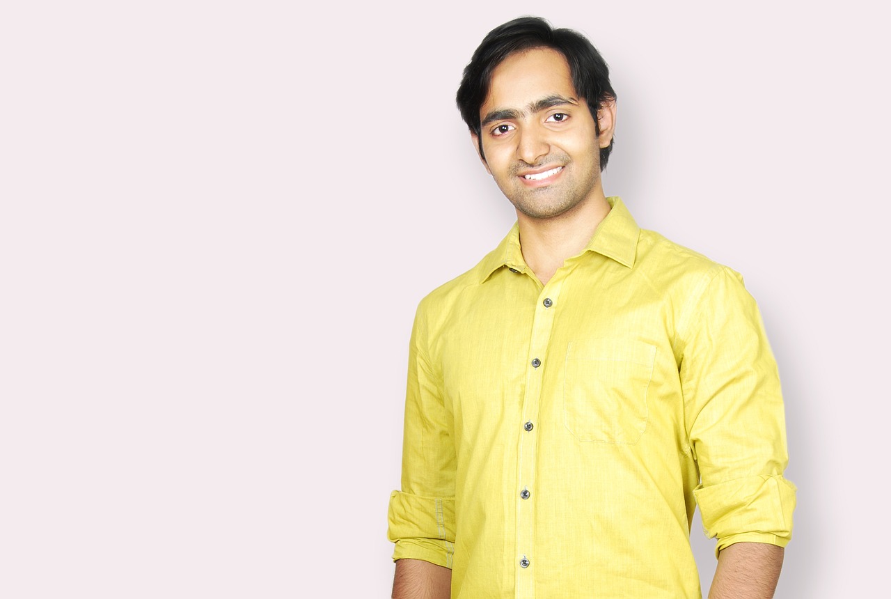 a man in a yellow shirt posing for a picture, inspired by Jitish Kallat, clean background, avatar for website, around 1 9 years old, high-resolution photo