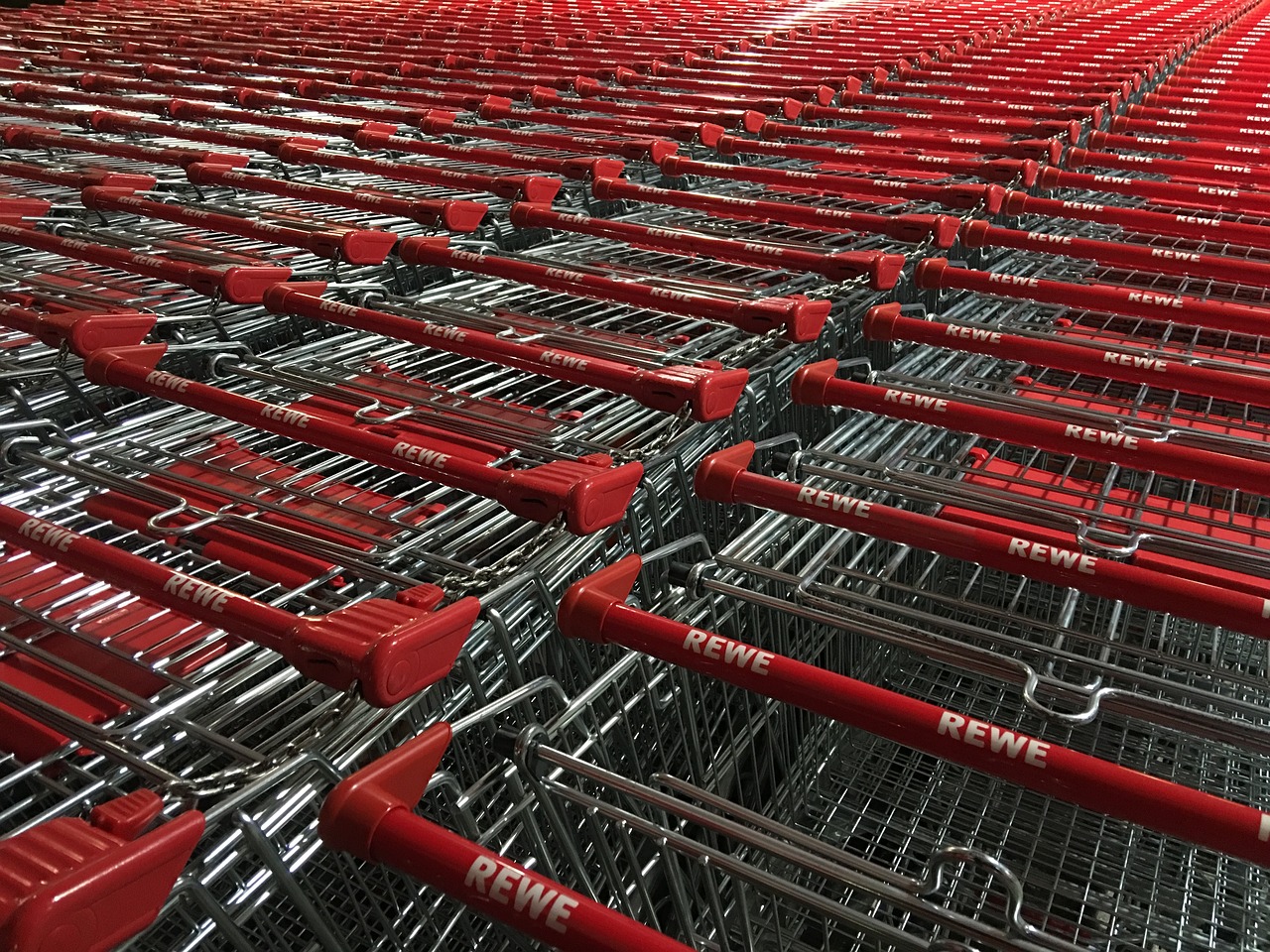 a bunch of red shopping carts sitting next to each other, a picture, by Armin Hansen, happening, shot with iphone 1 0, mega-detailed, staples, shot on leica sl2