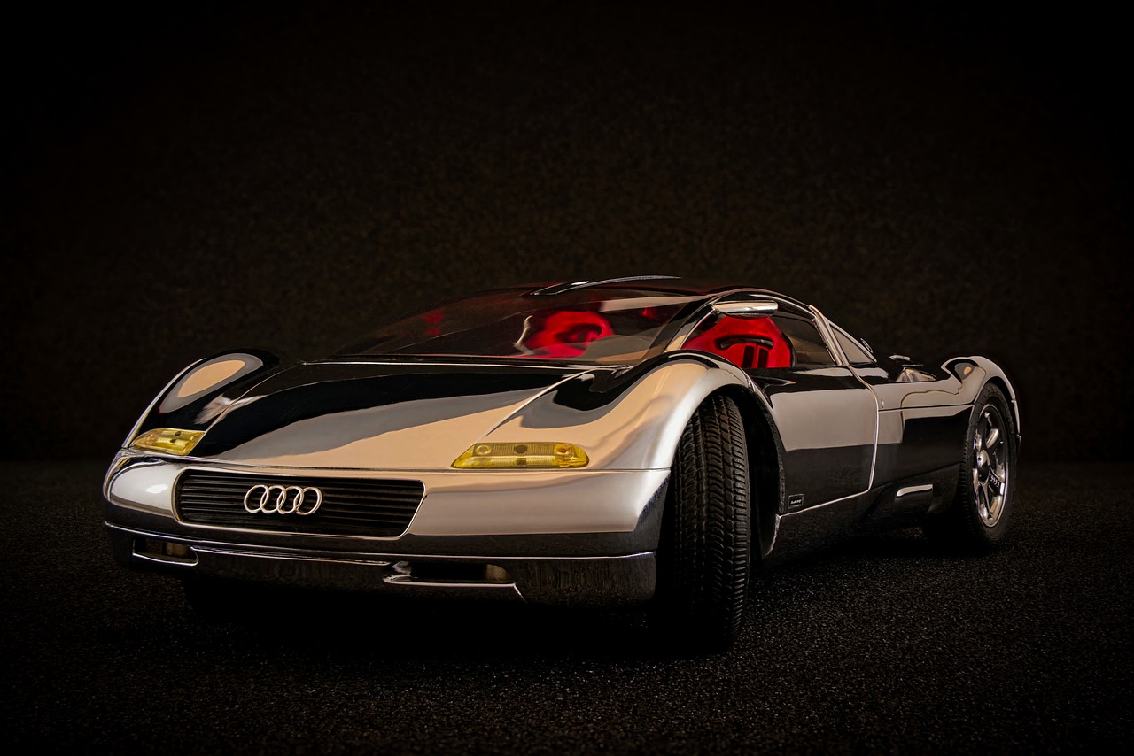 a silver and red sports car in a dark room, a 3D render, inspired by Harry Haenigsen, unsplash, altermodern, toy photo, vertical wallpaper, transparent carapace, photorealism. trending on flickr