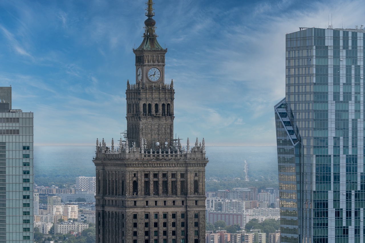 a tall clock tower towering over a city, a picture, by Adam Marczyński, pexels contest winner, socialist realism, aerial photograph of skyscraper, 1128x191 resolution, warsaw, wikimedia commons