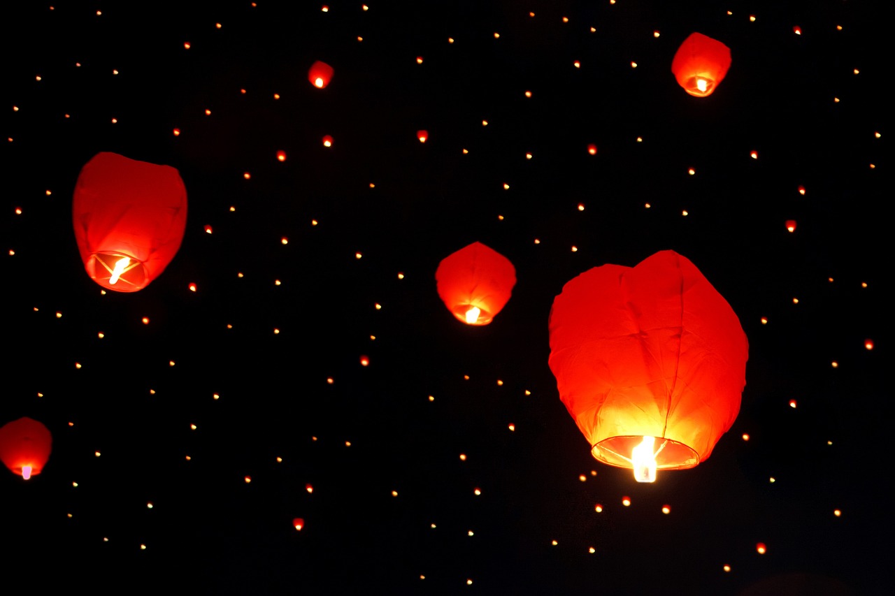 a sky filled with lots of red paper lanterns, light and space, with a black background, floating among stars, amber, square