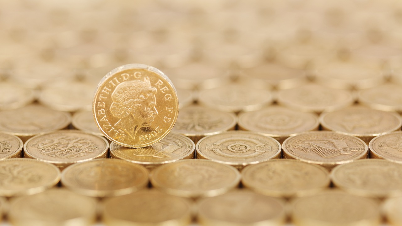 a coin sitting on top of a pile of coins, by Alison Watt, photostock, high res, britain, a large