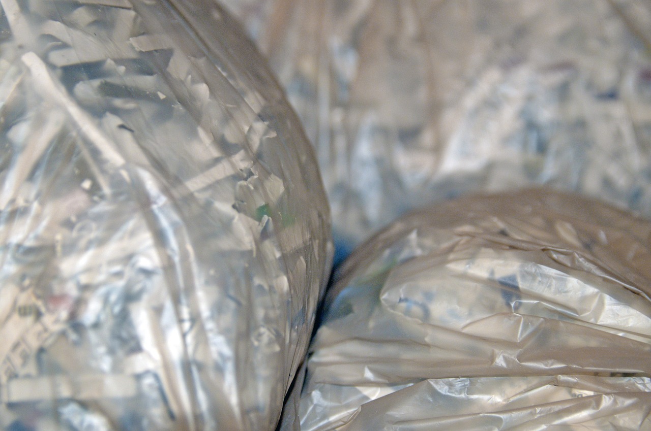 a pile of garbage bags sitting next to each other, flickr, plasticien, blurred detail, shiny silver, portrait image, version 3