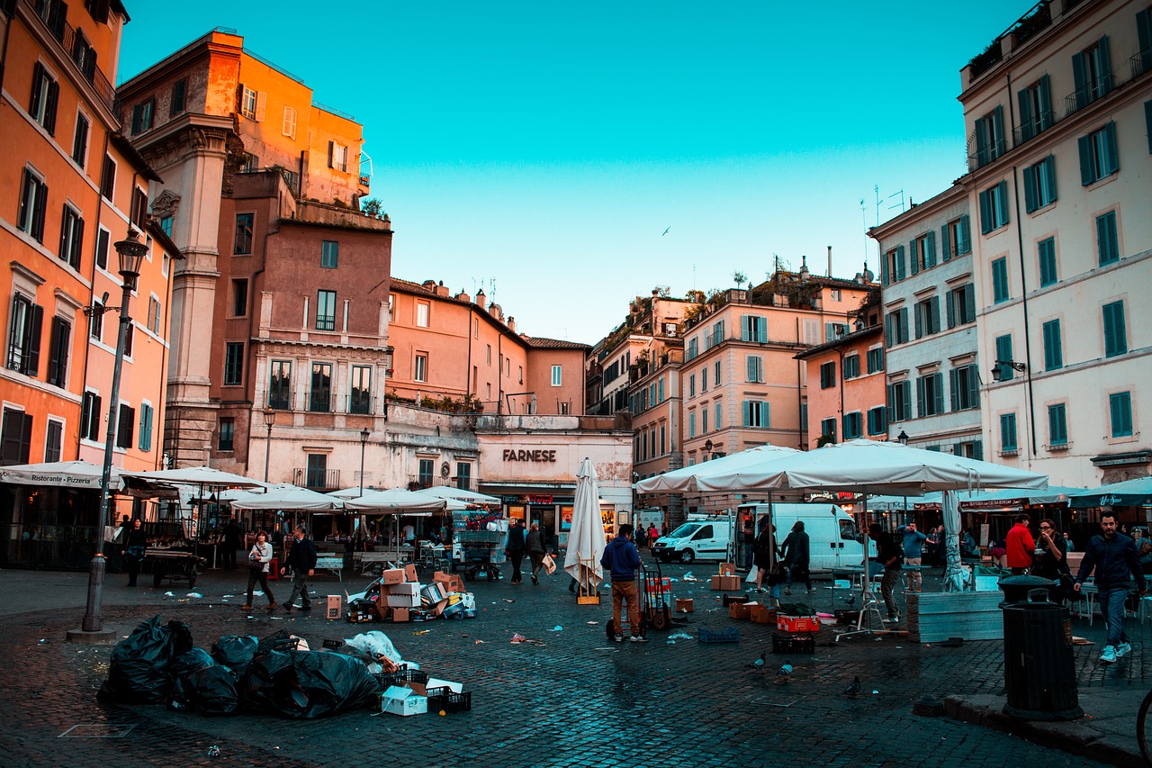 a group of people that are standing in the street, a tilt shift photo, shutterstock, realism, market in ancient rome, belongings strewn about, false color, skies behind