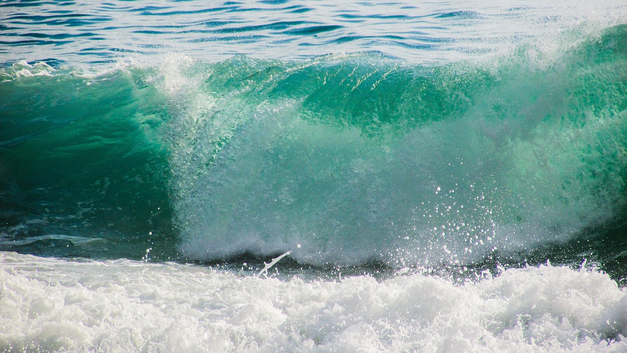 a man riding a wave on top of a surfboard, a picture, by Richard Carline, shutterstock, tones of blue and green, glistening seafoam, southern california, curves!!