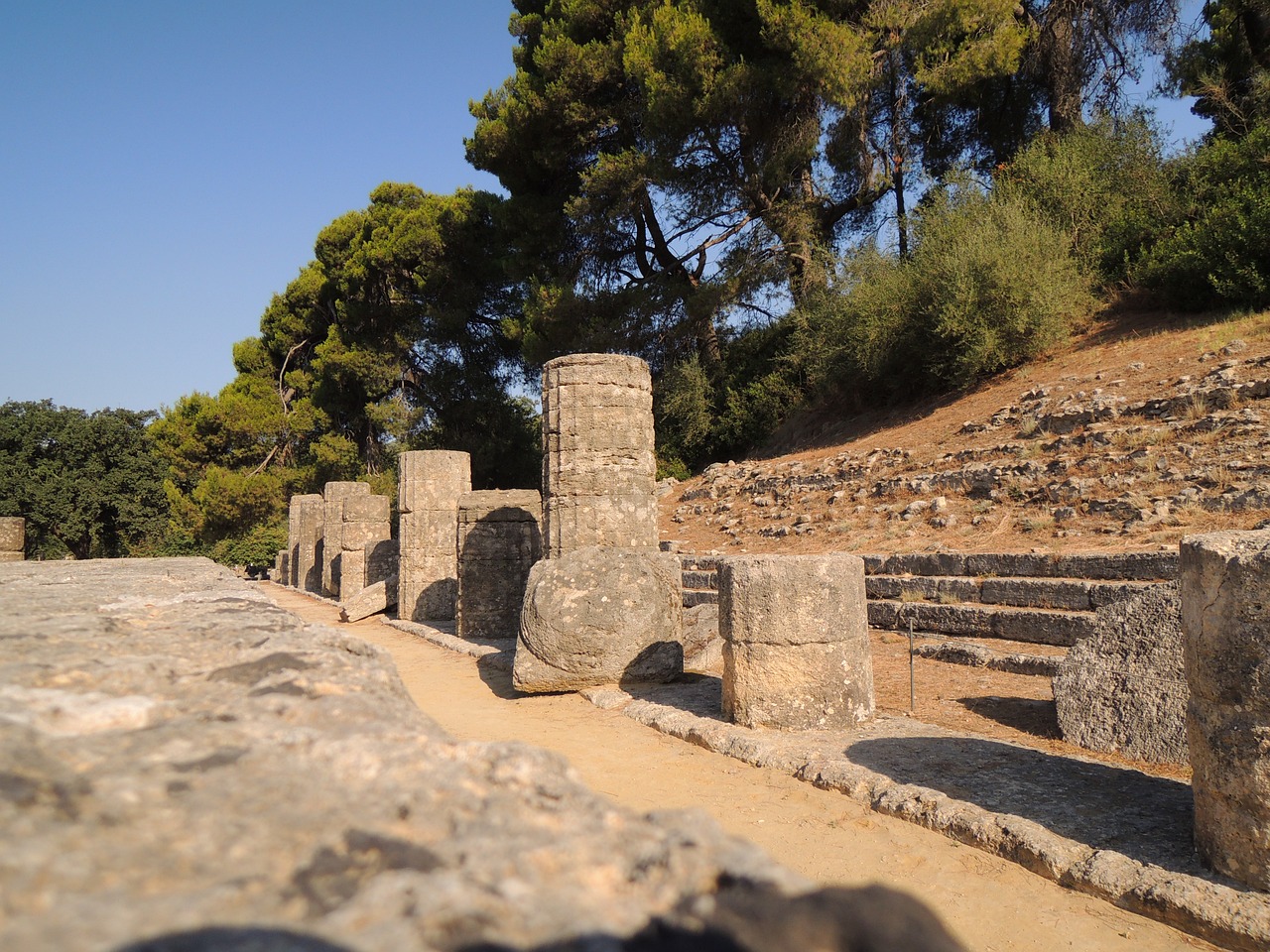 a group of stone pillars sitting next to each other, a picture, flickr, realism, an ancient greek trireme, ancient ruins in the forest, camera photo, olympus platform