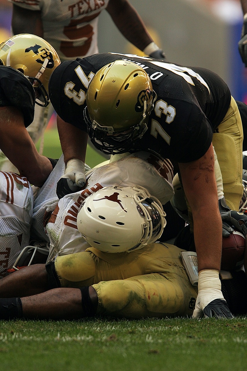 a group of men playing a game of football, a picture, by Douglas Shuler, unsplash, dada, brown and gold, full helmet, injured, texas