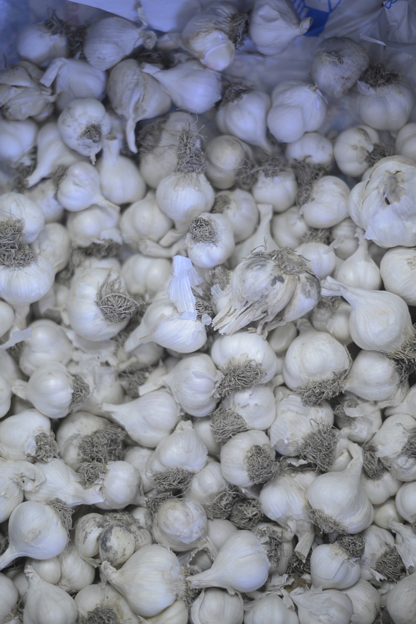 a bunch of garlic sitting on top of a table, by Paul Davis, hurufiyya, filling the frame, high quality product image”