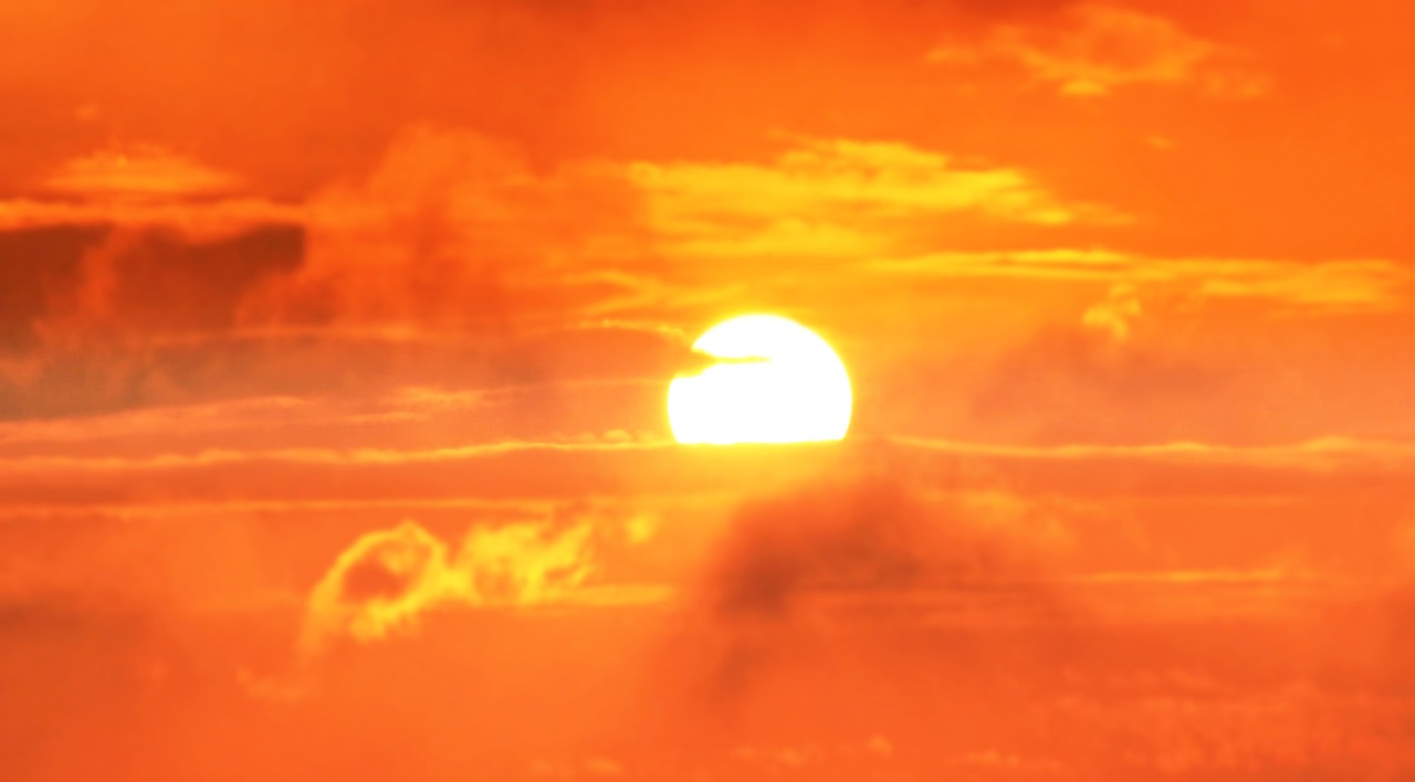 the sun is setting behind the clouds in the sky, romanticism, video still, digital yellow red sun, heat waves, image