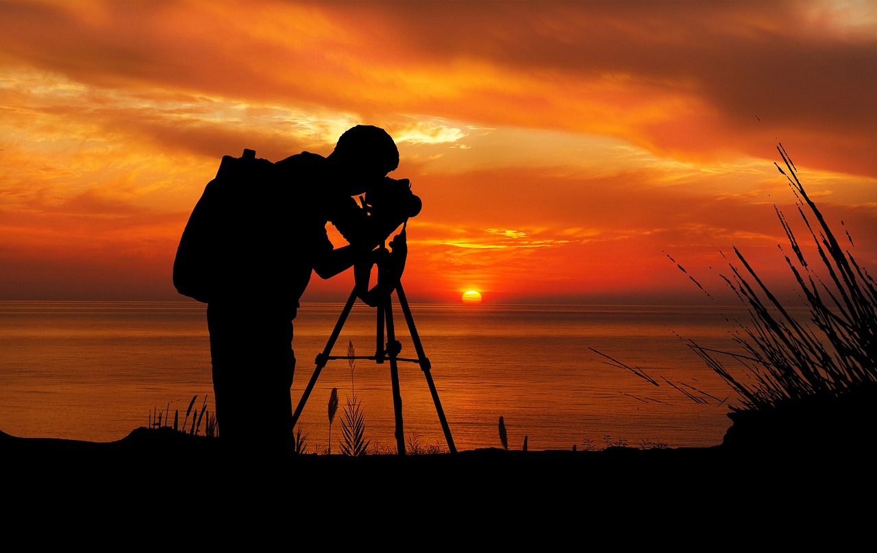 a man that is standing in front of a camera, a picture, by Tom Carapic, shutterstock, art photography, sunset!!!, long lens, scientific photo, with back to the camera