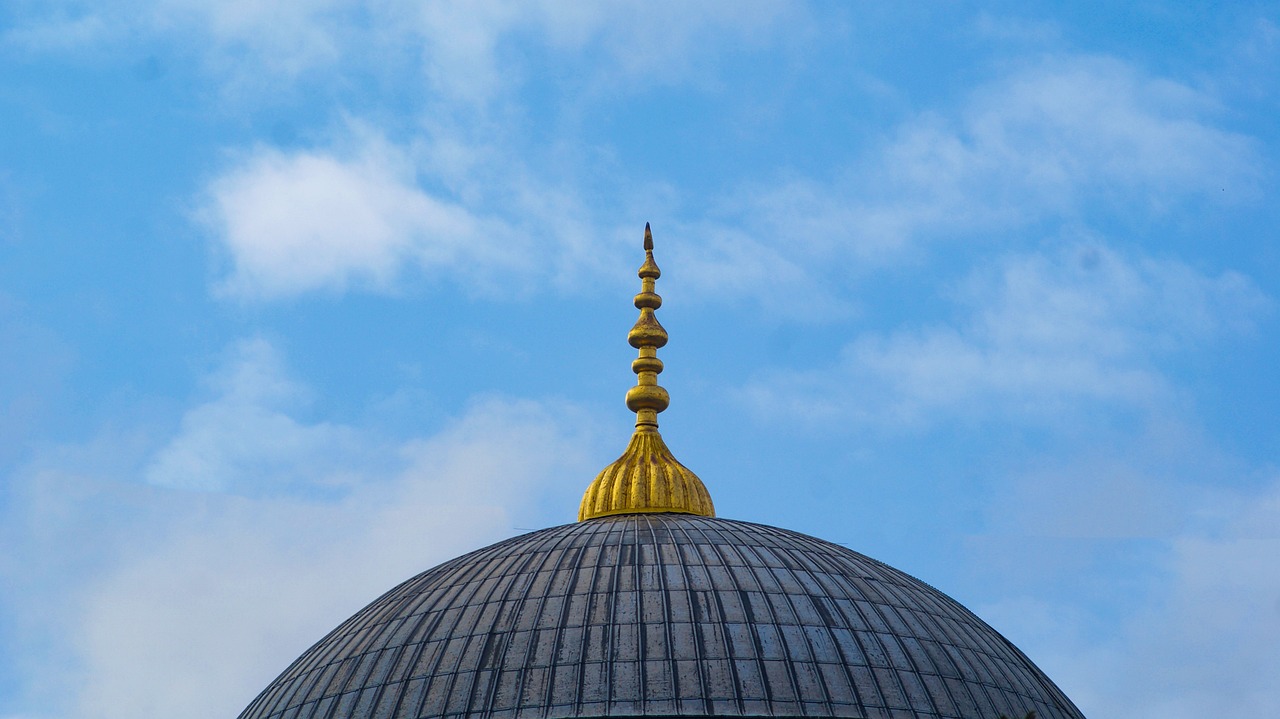 a close up of a dome with a clock on it, a tilt shift photo, inspired by Osman Hamdi Bey, arabesque, blue sky above, turban, modern high sharpness photo, cathedral of sun