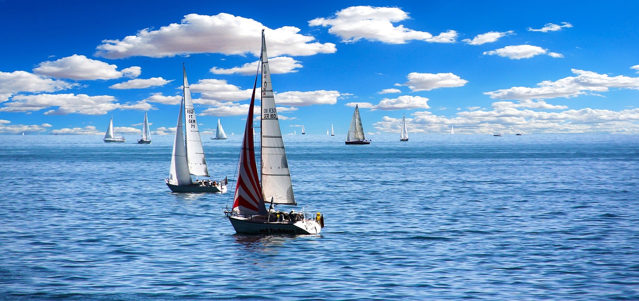 a group of sailboats floating on top of a body of water, pixabay, high definition screenshot, on a bright day, true realistic image, small boat in foreground