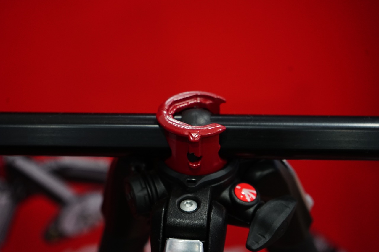 a close up of a camera on a tripod, by Romain brook, curved red arrow, it has a red and black paint, key is on the center of image, rack focus