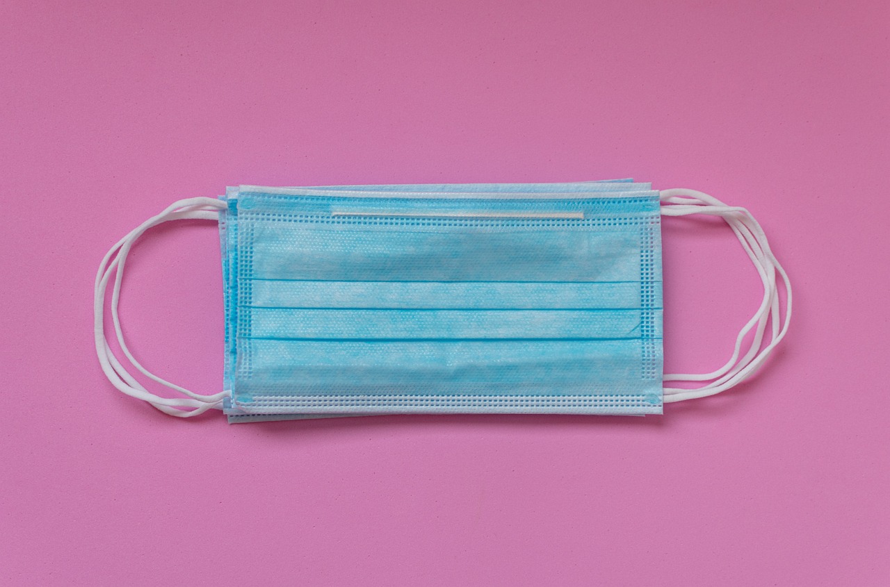 a blue face mask on a pink background, plasticien, sterile, background bar, display item, nursing