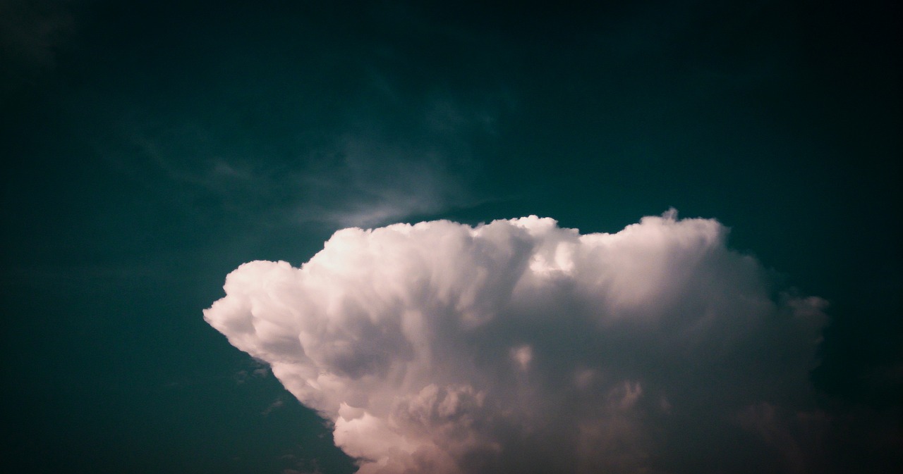 a large cloud in the middle of a blue sky, a picture, minimalism, 4k uhd wallpaper, stormy lighting, green sky, ominous photo