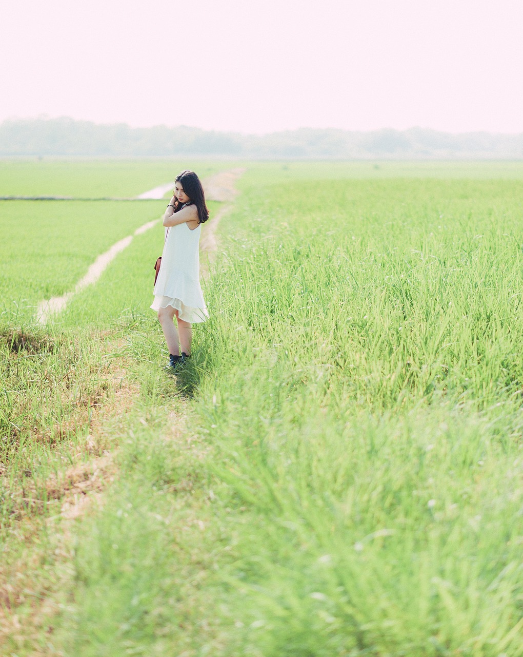 a woman in a white dress walking through a field, by Tan Ting-pho, romantic greenery, portra, shojo, near farm