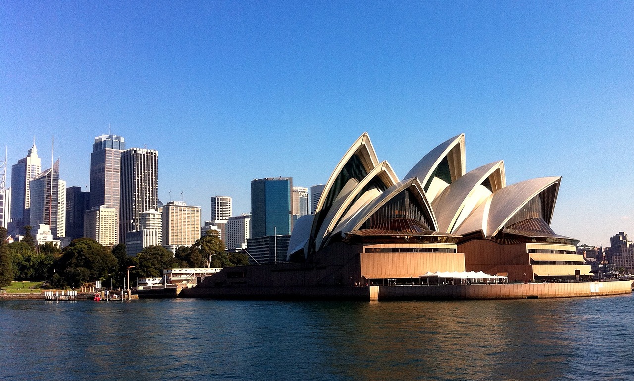 a view of the sydney opera house from across the water, inspired by Sydney Carline, flickr, sunny afternoon, gorgeous buildings, shiny skin”