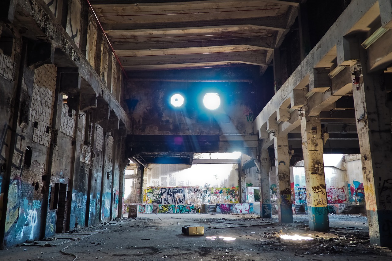 a room filled with lots of graffiti covered walls, by William Woodward, pexels contest winner, large glowing eyes, in the middle of round ruins, searchlight, harsh sun light