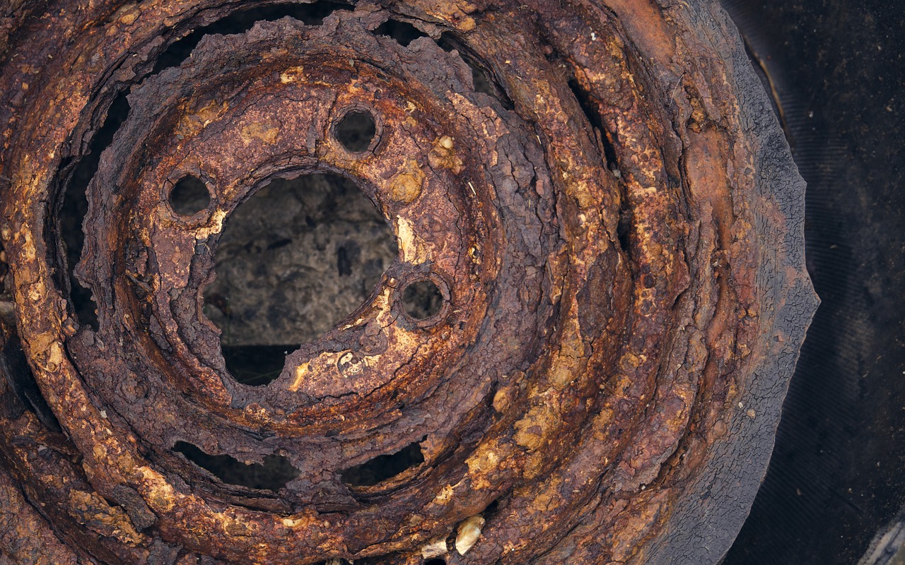 a rusted tire with a hole in the center, a portrait, by Jan Kupecký, flickr, exposed metal bones, detailed color scan, bubbling cauldron, close-up from above