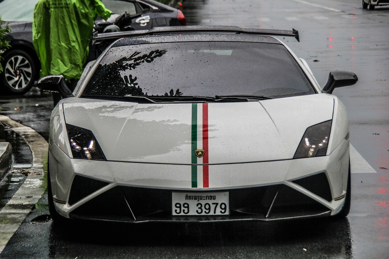 a white sports car parked on the side of the road, a photo, inspired by Bernardo Cavallino, unsplash, renaissance, italian flag, inside on a rainy day, triangle, front