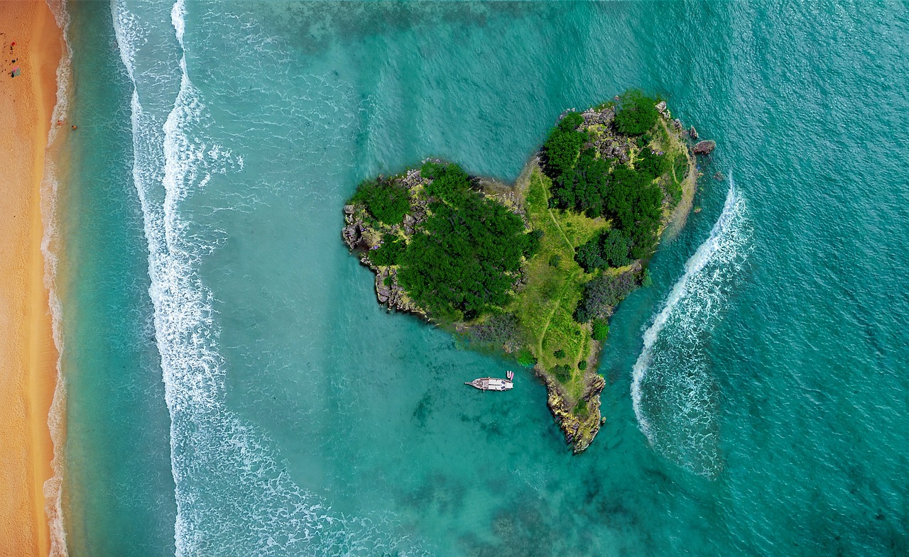 a heart shaped island in the middle of the ocean, a photo, by Richard Carline, environmental art, beautiful random images, shot on nikon z9, reggae, beautifully disturbing